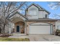 Charming two-story home featuring stone accents and a covered front porch with welcoming seating at 6657 Drew Ranch Ln, Boulder, CO 80301