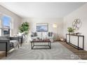 Bright living room with neutral tones, large windows, and stylish furnishings at 843 W Willow St, Louisville, CO 80027