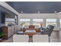Bright living room boasts a modern, open-concept design with sleek furniture and ample natural light at 1079 Larkspur Dr, Erie, CO 80516