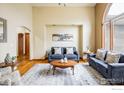 Comfortable living room featuring large windows, hardwood floors, and cozy seating with stylish area rug at 115 Grand View Dr, Mead, CO 80542