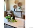 Neutral-toned living room showcases decor, plants, and a marble-topped table with a console table and woven baskets at 1201 Balsam Ave # 203, Boulder, CO 80304