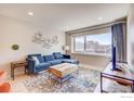 Comfortable living room with a blue sectional couch, decorative rug, and minimalist decor at 1201 Balsam Ave # 203, Boulder, CO 80304
