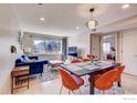 Cozy living space with blue sofa and orange dining set, offering mountain view from the window at 1201 Balsam Ave # 203, Boulder, CO 80304