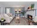 Cozy living room with a stone fireplace, stylish decor, and comfortable seating arrangement at 12450 E Cornell Ave # 304, Aurora, CO 80014