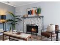 Bright living room showcasing a stone fireplace, modern art, and a neutral color palette at 12450 E Cornell Ave # 304, Aurora, CO 80014