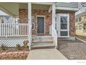 Inviting front porch with brick accents, decorative details, and well-maintained steps leading to the entrance at 14031 Blue River Trl, Broomfield, CO 80023