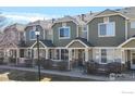 Charming townhouse exterior with a manicured lawn and inviting front porch, a perfect place to call home at 16047 E Geddes Ln # 128, Aurora, CO 80016