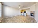 Bright and airy living room boasting wood floors and an open layout connecting to the modern kitchen at 16047 E Geddes Ln # 128, Aurora, CO 80016