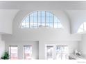 A vaulted ceiling featuring a large window, fan, and other standard windows at 1699 N Downing St # 409, Denver, CO 80218