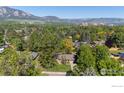 Stunning aerial view showcasing the lush greenery and mountain backdrop at 255 Kiowa Pl, Boulder, CO 80303