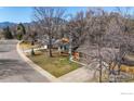 Aerial view of a home showcasing its roof, driveway, and surrounding landscape, including mature trees at 255 Kiowa Pl, Boulder, CO 80303