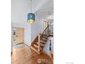 Welcoming foyer with wooden floors, staircase, and stylish pendant light, creating a grand entrance at 255 Kiowa Pl, Boulder, CO 80303