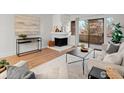 Bright living room with fireplace, modern furniture and decor, and a sliding glass door to a balcony at 3120 Corona Trl # 301, Boulder, CO 80301