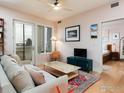 Bright living room features a ceiling fan, balcony access, and an adjacent bedroom at 3701 Arapahoe Ave # 304, Boulder, CO 80303