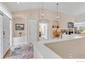 Inviting home foyer featuring a high ceiling, chandelier lighting, decorative archways, hardwood floors, and a bright, airy feel at 462 Blue Lake Trl, Lafayette, CO 80026