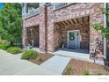 Inviting entrance with brick facade and covered porch, decorated with a wreath at 5437 W 97Th Pl, Westminster, CO 80020