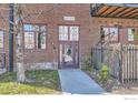 Ground level entrance into brick building featuring brick facade, frosted door, and metal railing at 1000 E 18Th Ave, Denver, CO 80218