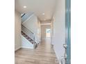 Inviting entryway with wood floors, staircase, and natural light, creating a warm and welcoming atmosphere at 13 Chipeta Way, Lochbuie, CO 80603