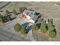 An aerial view showcasing the home and its surrounding landscaping and neighborhood at 16498 S Essex S Rd, Platteville, CO 80651