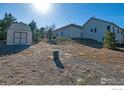 A spacious backyard featuring a storage shed and natural landscaping at 16498 S Essex S Rd, Platteville, CO 80651