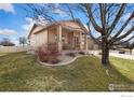 Charming home featuring a cozy front porch and a well-maintained lawn at 175 Redcloud Ave, Berthoud, CO 80513