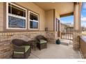 Charming front porch with seating provides a welcoming entrance to the home at 175 Redcloud Ave, Berthoud, CO 80513