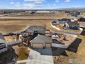 Captivating aerial view showcases a home with a spacious yard, backing to open space, offering privacy at 2100 Cadman St, Berthoud, CO 80513