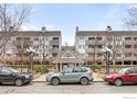 Exterior of condo building with brick road, guest parking, and car parking at 2201 Pearl St # 110, Boulder, CO 80302