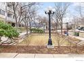 Manicured lawn area with lamp posts and benches in a park-like setting at 2201 Pearl St # 110, Boulder, CO 80302