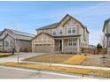 Charming two-story home with a well-manicured lawn and inviting front porch at 316 Taurus Dr, Erie, CO 80516
