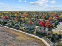 Aerial view featuring home surrounded by colorful foliage and a walking path at 3916 Fowler Ln, Longmont, CO 80503