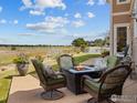 Inviting patio with comfortable seating and fire pit, offering picturesque outdoor living at 3916 Fowler Ln, Longmont, CO 80503