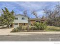 Two-story home boasts a brick and siding exterior, complemented by lush landscaping and a well-maintained lawn at 4288 Graham Ct, Boulder, CO 80305
