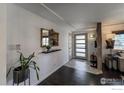 Inviting entryway featuring stylish tile flooring, decorative mirror, and modern accents at 4360 Ludlow St, Boulder, CO 80305