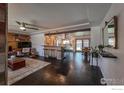 Open-concept living room with hardwood floors, bar seating, and abundant natural light at 4360 Ludlow St, Boulder, CO 80305
