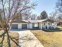 Ranch style home with attached garage, features a covered porch and well-maintained yard at 4500 Osage Dr, Boulder, CO 80303
