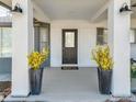 Inviting covered entry with stylish black door and decorative plants, providing curb appeal at 4500 Osage Dr, Boulder, CO 80303