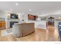 Spacious living room featuring a stone fireplace, open floor plan, and hardwood floors at 4500 Osage Dr, Boulder, CO 80303