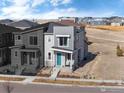 Attractive two-story home featuring a modern exterior design and a bright blue front door at 5351 Warrior St, Frederick, CO 80504