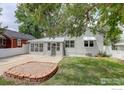 Charming single Gathering home featuring a sunroom, landscaped yard, and mature trees at 724 Carbon St, Erie, CO 80516