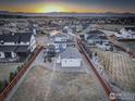 Spacious backyard with privacy fence and mountain views in a Primary-planned community at sunrise at 785 Delechant Dr, Erie, CO 80516