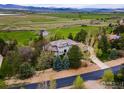 Estate aerial view features lush grounds and manicured lawns, blending sophistication with a natural landscape at 8845 Crimson Clover Ln, Longmont, CO 80503