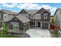 Charming two-story home boasts meticulous landscaping, and a welcoming facade with stone accents and a cozy front porch at 890 Meadowlark Dr, Erie, CO 80516