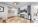 Bright living room featuring hardwood floors, recessed lighting, and modern entertainment center perfect for relaxation at 890 Meadowlark Dr, Erie, CO 80516