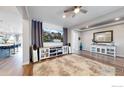 Bright living room featuring hardwood floors, recessed lighting, and modern entertainment center perfect for relaxation at 890 Meadowlark Dr, Erie, CO 80516