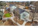 An aerial view captures the home's attractive setting, complete with lush greenery and mature trees at 954 11Th Ave, Longmont, CO 80501