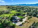 Expansive aerial view showing the home, surrounding landscape, and distant mountains at 1000 Spring Dr, Boulder, CO 80303