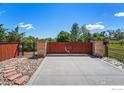 Image of a gated driveway with a wood and iron gate and stone pillars at 1000 Spring Dr, Boulder, CO 80303