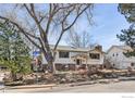 Beautiful two-story home surrounded by mature trees and a well-maintained front yard at 1120 Green Cir, Boulder, CO 80305