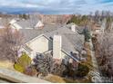 An elevated aerial view of the roof and trees of a single Gathering home at 1333 Charles Dr # 15, Longmont, CO 80503